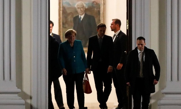 Chancellor Angela Merkel leaves after a joint meeting with Horst Seehofer, the head of the Bavarian Christian Social Union (CSU) and the leader of the Social Democrats (SPD) Martin Schulz, hosted by the German President Frank-Walter Steinmeier, in Schloss