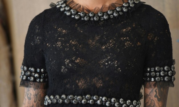 A model shows a Chanel Demi Couture 2007 Fall/Winter black lace evening gown with rhinestones, estimated at $11,000-$12,000, at a media preview for the world's first live streaming runway auction
