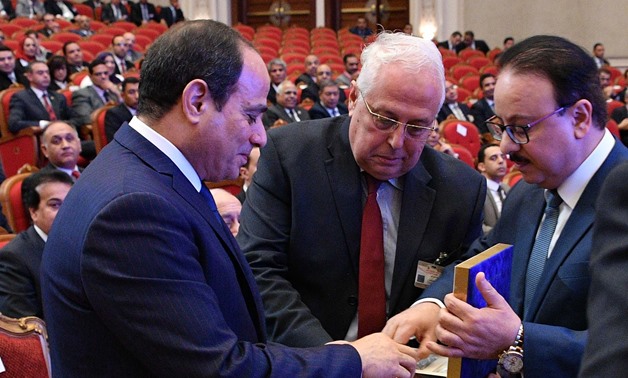 Minister of Communication Yasser El Kady handing President Sisi the first Egypt-made smart phone during Cairo ICT 2017 conference- Presidency photo