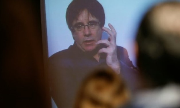 © AFP | Carles Puigdemont, spaking to supporters in Barcelona via video-conference on Sunday, presents his independence party's electoral programme
