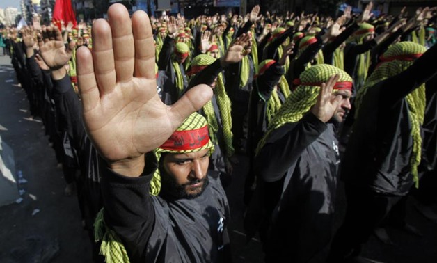 Lebanese Hezbollah supporters gesture as they march during a religious procession to mark Ashura in Beirut's suburbs November 14, 2013. REUTERS/Sharif Karim