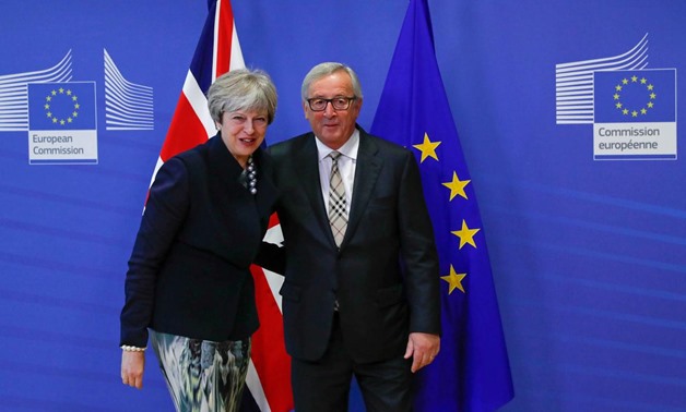 Britain's Prime Minister Theresa May is welcomed by European Commission President Jean-Claude Juncker at the EC headquarters in Brussels, Belgium December 4, 2017. REUTERS/Yves Herman
