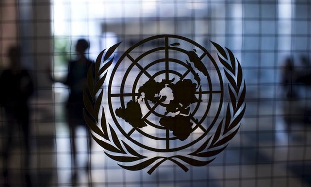 A United Nations logo is seen on a glass door in the Assembly Building at the United Nations headquarters in New York City September 18, 2015. REUTERS/Mike Segar
