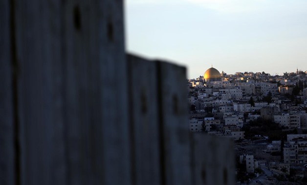 The Dome of the Rock and Jerusalem's Old City can be seen over the Israeli barrier from the Palestinian town of Abu Dis in the West Bank east of Jerusalem December 4, 2017. REUTERS/Ammar Awad
