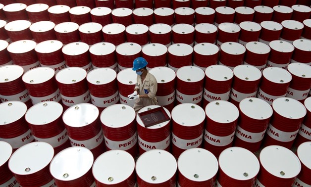A worker prepares to label barrels of lubricant oil at the state oil company Pertamina's lubricant production facility in Cilacap, Central Java, Indonesia November 6, 2017 in this photo taken by Antara Foto. Picture taken November 6, 2017. Antara Foto/Ros