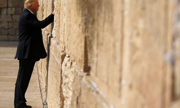 U.S. President Donald Trump places a note in the stones of the Western Wall, Judaism's holiest prayer site, in Jerusalem's Old City May 22, 2017 - REUTERS/Jonathan Ernst