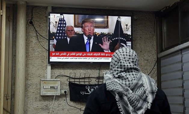 A picture taken on December 6, 2017 shows a Palestinian man at a cafe in Jerusalem watching an address given by US President Donald Trump. (Ahmad GHARABLI/AFP)