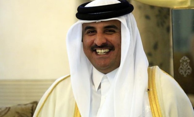 Qatar's Emir Sheikh Tamim bin Hamad al-Thani smiles as he is welcomed upon arriving at Khartoum Airport for an official visit April 2, 2014. REUTERS/Mohamed Nureldin Abdallah
