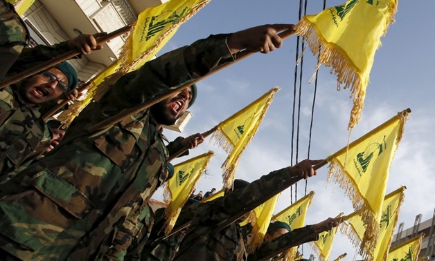 Lebanon’s Hezbollah members carry Hezbollah flags during the funeral of their fellow fighter Adnan Siblini, who was killed while fighting against insurgents in the Qalamoun region, in al-Ghaziyeh village, southern Lebanon May 26, 2015. REUTERS/Ali Hashish