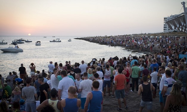 Tourists enjoy the sunset at Cafe del Mar on Ibiza Island on July 10, 2015. AFP Photo/Jaime Reina
