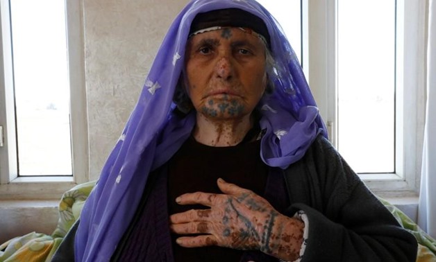 Fatma Dogru (70) poses as she speaks about her tattoos at her home in Kisas village in southeastern province of Sanliurfa, Turkey, November 22, 2017. Picture taken November 22, 2017. REUTERS/Umit Bektas
