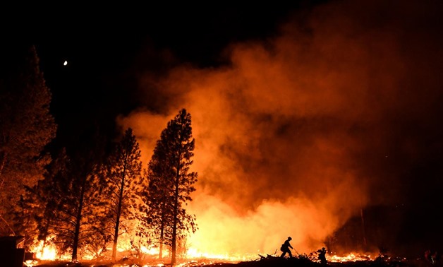 A firefighter battles the Ponderosa Fire east of Oroville, California. REUTERS/Noah Berger

