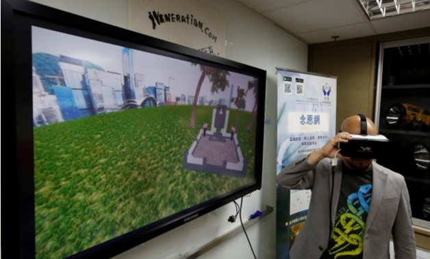 Anthony Yuen, CEO of iVeneration.com, demonstrates an augmented reality graveyard at his office in Hong Kong, China, November 13, 2017. Picture taken November 13, 2017 - REUTERS/Bobby Yip