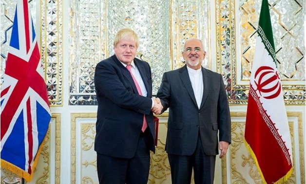 Iran's Foreign Minister Mohammad Javad Zarif shakes hands with Britain's Foreign Secretary Boris Johnson during their meeting in Tehran December 9, 2017. Tasnim News Agency/Handout via REUTERS