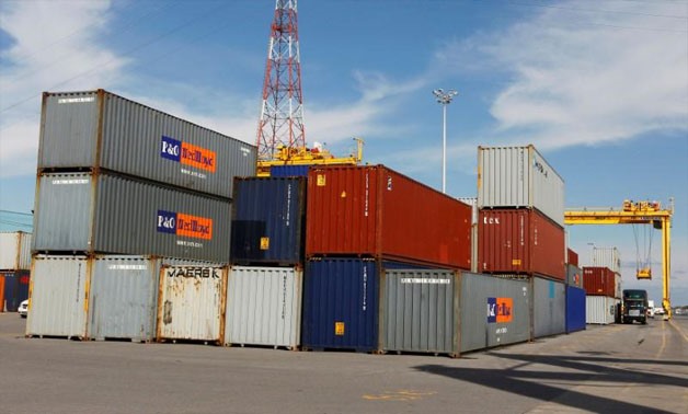 A truck is loaded with a container at the Port of Montreal, September 27, 2010. REUTERS/Shaun Best/File Photo