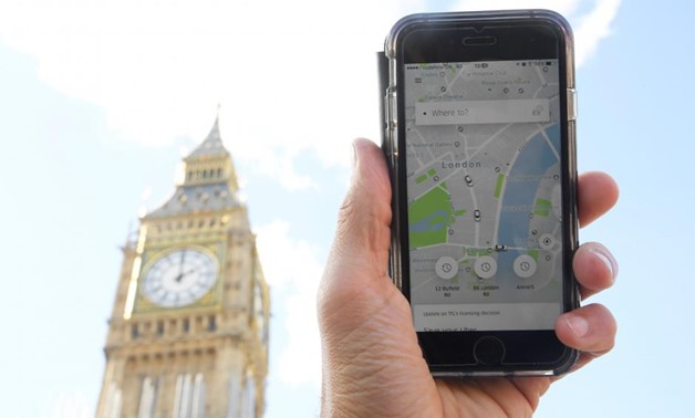 A photo illustration shows the Uber app on a mobile telephone, as it is held up for a posed photograph in central London, Britain September 22, 2017. REUTERS/Toby Melville
