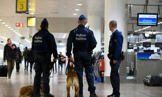 Police officers stand guard outside Brussels Airport, in Zaventem, on March 23, 2016, a day after triple bomb attacks at the Brussels airport and at a subway train station
Yorick Jansens (POOL/AFP)