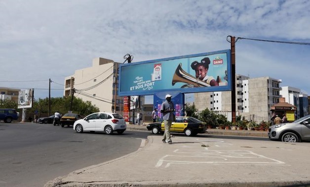 A man walks across a street along de la Corniche in Dakar, Senegal December 19, 2016. Picture taken December 19, 2016. REUTERS/Afolabi Sotunde
