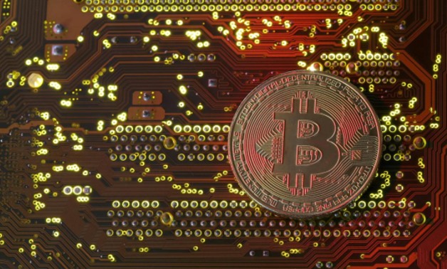 A copy of bitcoin standing on PC motherboard is seen in this illustration picture, October 26, 2017. REUTERS/Dado Ruvic/File Photo