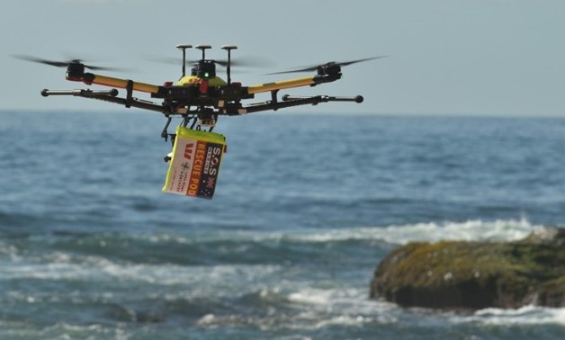 A shark-spotting drone with safety flotation device attached flies over Bilgola beach, Sydney-AFP