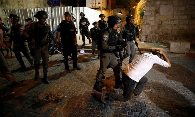 Israeli border police disperse a Palestinian man during scuffles that erupted after Palestinians held evening prayers outside the Lion's Gate of Jerusalem's Old City July 18, 2017. REUTERS/Ammar Awad