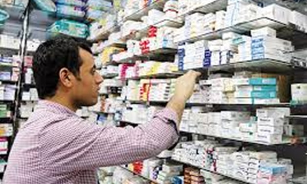 A pharmacist searches for medicine at a pharmacy in Cairo, Egypt, November 17,. CAIRO / Reuters