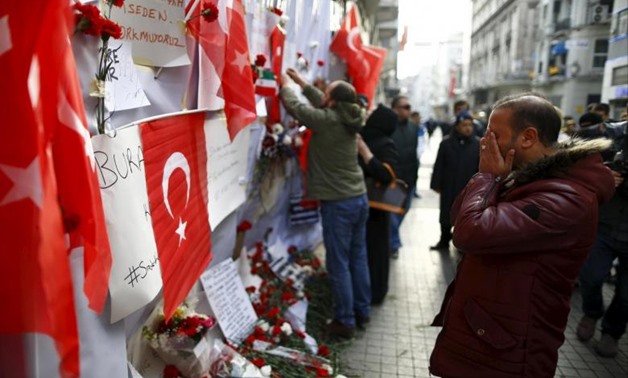 A man prays at the scene of a suicide bombing at Istiklal street, a major shopping and tourist district, in central Istanbul, Turkey March 20, 2016. REUTERS/Osman Orsal