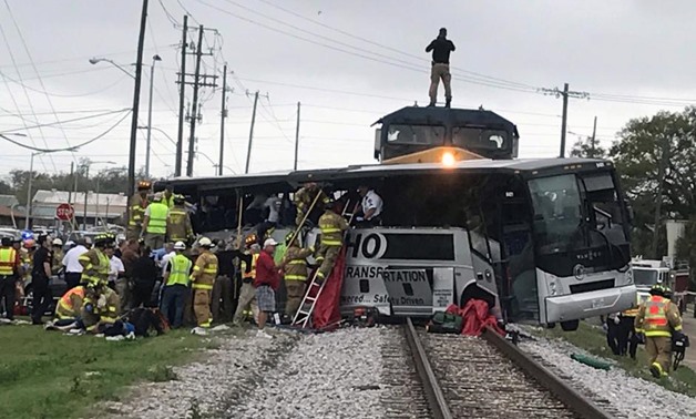 Biloxi firefighters help passengers escape the wreckage after a train travelling from Austin, Texas, collided with a charter bus in Biloxi, Mississippi, U.S., March 7, 2017. REUTERS/John Fitzhugh/Biloxi SunHerald