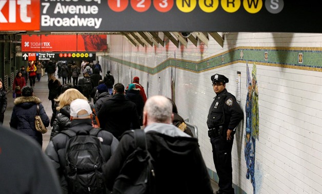FILE PHOTO: A New York City Police (NYPD) officer stands in the subway corridor, at the New York Port Authority subway station near the site of an attempted detonation the day before, in New York City, U.S. December 12, 2017. REUTERS/Brendan McDermid