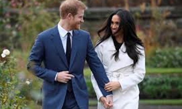 Britain's Prince Harry poses with Meghan Markle in the Sunken Garden of Kensington Palace, London, Britain, November 27, 2017. REUTERS/Toby Melville/File Photo