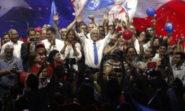 © AFP | Chilean presidential candidate Sebastian Pinera (C), shown during his final campaign rally on December 14, 2017, won a lower-than-expected percentage of the vote in November's first round