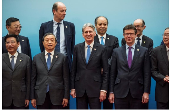 Britain's Chancellor of the Exchequer Philip Hammond and Chinese Vice Premier Ma Kai pose with delegates during the UK-China Economic Financial Dialogue at the Diaoyutai State Guesthouse in Beijing, China December 16, 2017. REUTERS/Fred Dufour/Pool
