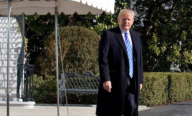 U.S. President Donald Trump walks out from the White House in Washington, U.S., before his departure to Camp David, December 16, 2017. REUTERS/Yuri Gripas
