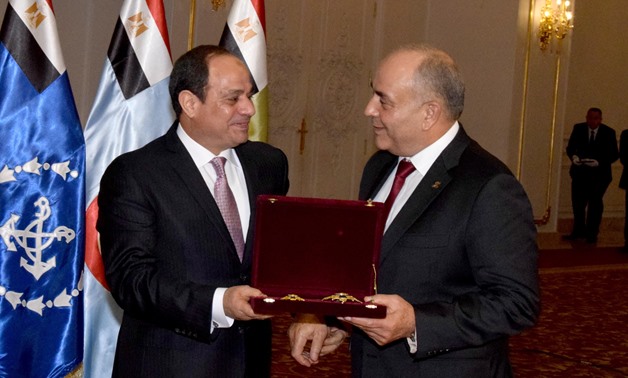 President Abdel Fatah al-Sisi (L) bestows Order of the Republic of the First Class on former Chief of Staff of the Armed Forces, Colonel General Mahmoud Hegazy (R) on Saturday, December 16, 2017- Press photo