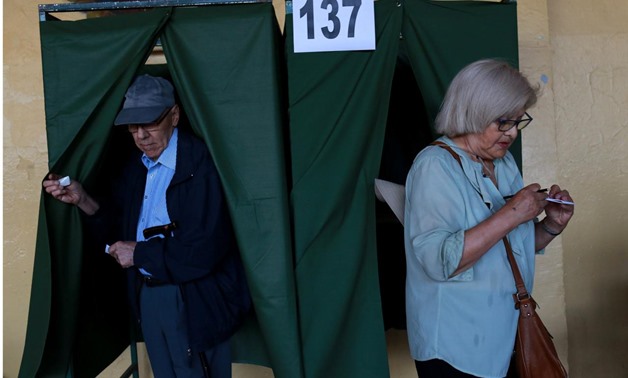 Citizens leave from voting booths inside a polling station during the presidential election at Santiago, Chile December 17, 2017. REUTERS/Pablo Sanhueza