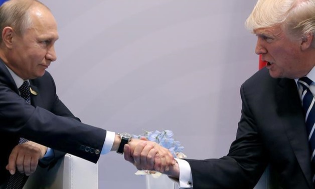 U.S. President Donald Trump shakes hands with Russian President Vladimir Putin during the their bilateral meeting at the G20 summit in Hamburg, Germany July 7, 2017. REUTERS/Carlos Barria
