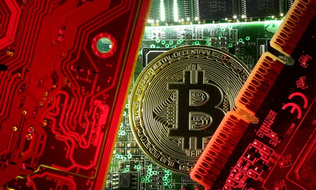 A copy of bitcoin standing on PC motherboard is seen in this illustration picture, October 26, 2017. REUTERS/Dado Ruvic/File Photo