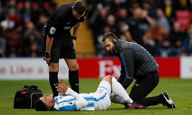 Soccer Football - Premier League - Watford vs Huddersfield Town - Vicarage Road, Watford, Britain - December 16, 2017 Huddersfield Town’s Elias Kachunga receives medical attention after sustaining an injury as referee Michael Oliver looks on REUTERS/David
