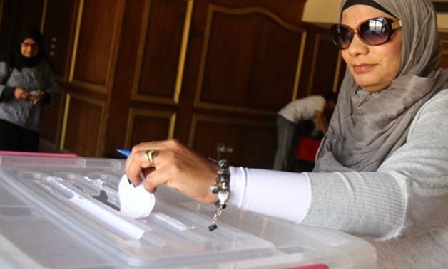 FILE – Egyptian woman casts her ballot in election box