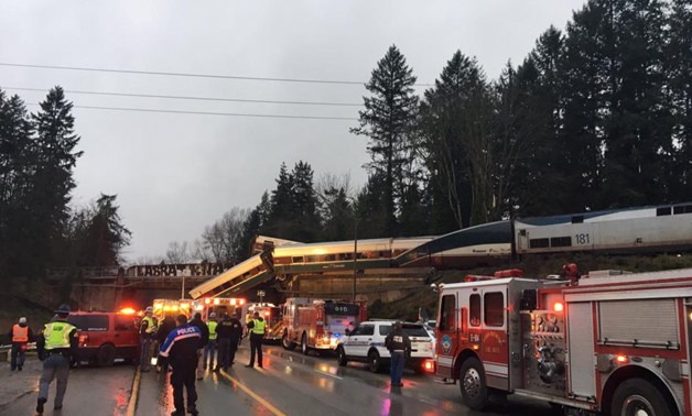 First responders are seen at the scene of an Amtrak passenger train derailment on interstate highway (I-5) in this Washington State Patrol image moved on social media in DuPont, Washington, U.S., December 18, 2017. Courtesy Brooke Bova/Washington State Pa