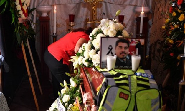 Veronica Castro Lopez, mother of photojournalist Edgar Esqueda, cries over the coffin during his wake in San Luis Potosi, Mexico on October 7, 2017 - AFP/Yuri Cortez