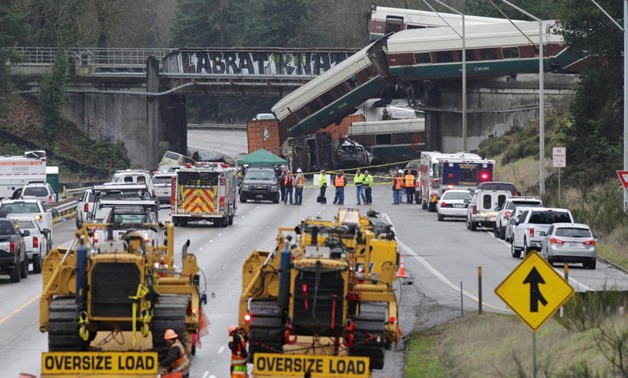 Rescue personnel and equipment are seen at the scene where an Amtrak passenger train derailed on a bridge over interstate highway I-5 in DuPont, Washington, U.S., December 18, 2017. REUTERS/Steve Dipaola