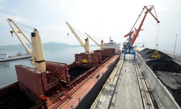 A cargo ship is loaded with coal during the opening ceremony of a new dock at the North Korean port of Rajin July 18, 2014. REUTERS/Yuri Maltsev