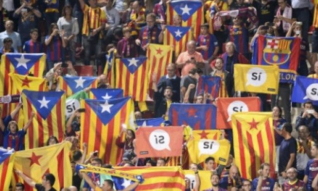 © AFP/File / by Kieran CANNING | In Barcelona Catalan flags, including the independence-supporting Estelada, are commonly flown, while the crowd chant in favour of independence in the 17th minute of each match to mark the fall of Catalonia in the Spanish 