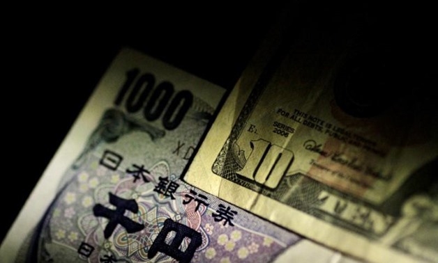 FILE PHOTO: U.S. Dollar and Japan Yen notes are seen in this June 22, 2017 illustration photo. REUTERS/Thomas White/Illustration