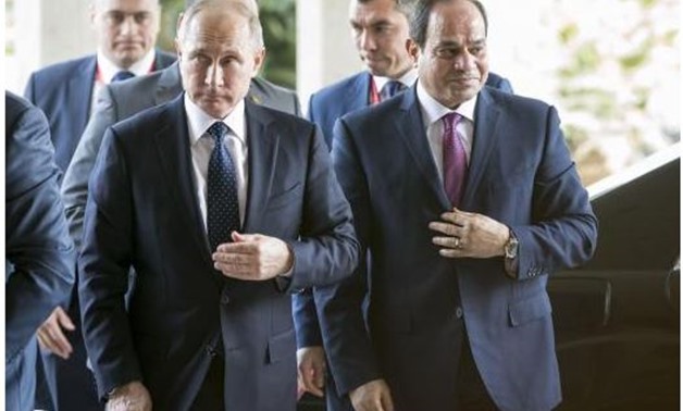 Russia's President Vladimir Putin (L) and Egypt's President Abdel Fattah al-Sisi walk during a meeting in Cairo, Egypt... POOL December 11, 2017