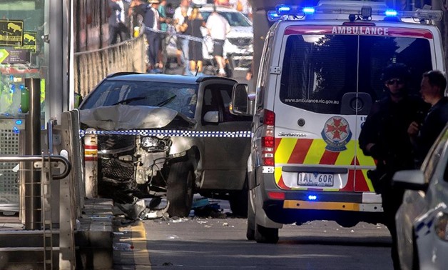 Australian police stand near a crashed vehicle after they arrested the driver of a vehicle that had ploughed into pedestrians at a crowded intersection near the Flinders Street train station in central Melbourne, Australia December 21, 2017. REUTERS/Luis 