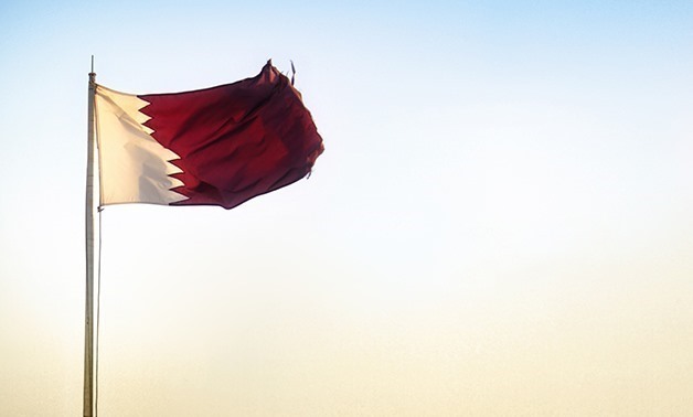 FILE – The flag of Qatar