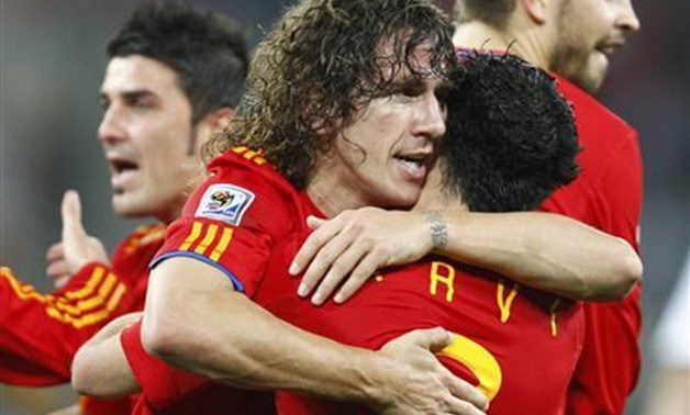 Spain's Carles Puyol (C) celebrates his goal with Xavi during the 2010 World Cup semi-final soccer match against Germany at Moses Mabhida stadium in Durban July 7, 2010 - REUTERS/Jerry Lampen 