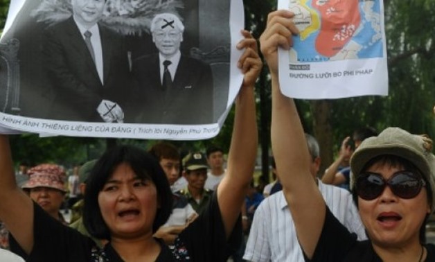 © AFP/File | Tran Thi Nga (L) shouting anti-China slogans as she takes part in a rally in Hanoi in 2013
